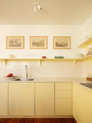 a kitchen with white cabinets and a sink at Carmo 33 in Funchal