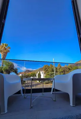 a view from a balcony with two chairs and a table at S A L - Beach Apartments Caniçal in Machico