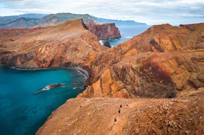 a group of people standing on the side of a mountain at S A L - Beach Apartments Caniçal in Machico