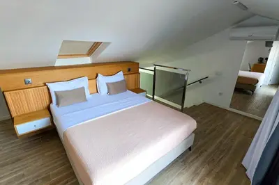 a bedroom with a large bed with a wooden headboard at S A L - Beach Apartments Caniçal in Machico