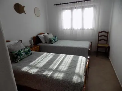 a bedroom with two beds and a window at Casa do Cercado, Sagres in Sagres