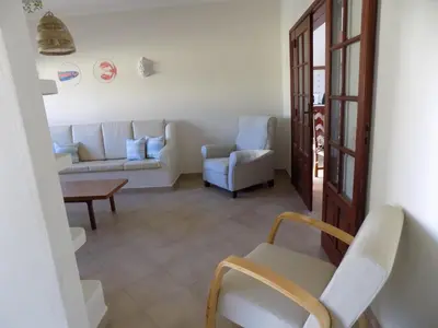 a living room with a couch and chairs and a table at Casa do Cercado, Sagres in Sagres
