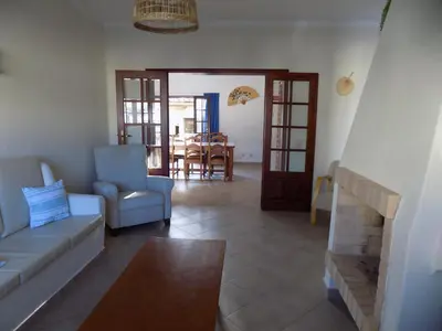 a living room with a couch and a table at Casa do Cercado, Sagres in Sagres