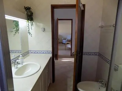a bathroom with a sink and a toilet and a mirror at Casa do Cercado, Sagres in Sagres