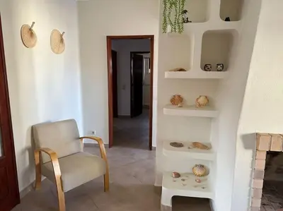 a room with a chair and some shells on shelves at Casa do Cercado, Sagres in Sagres