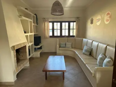 a living room with a couch and a fireplace at Casa do Cercado, Sagres in Sagres