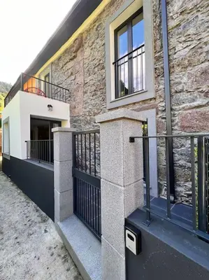 a brick building with a balcony on the side of it at Roots Guesthouse - A in São Vicente