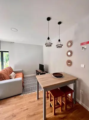 a living room with a table and a couch at Roots Guesthouse- B in São Vicente