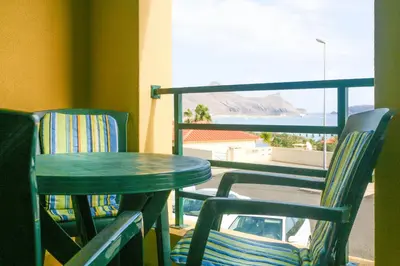 a table and two chairs sitting next to a window at Hadassa Sunrise Refuge in Porto Santo