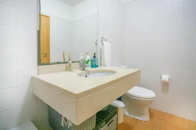 a bathroom with a sink and a toilet at Hadassa Sunrise Refuge in Porto Santo