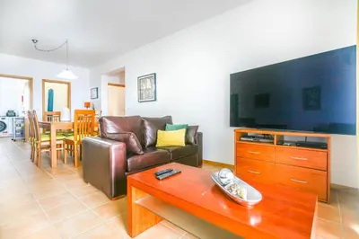 a living room with a couch and a table at Hadassa Sunrise Refuge in Porto Santo