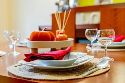 a table with a plate of food and wine glasses at Refúgio das Fontes in Senhora do Rosário