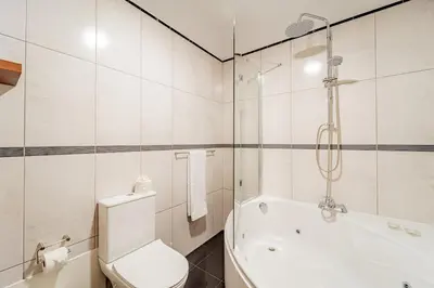 a bathroom with a toilet and a bath tub at Refúgio das Fontes in Senhora do Rosário