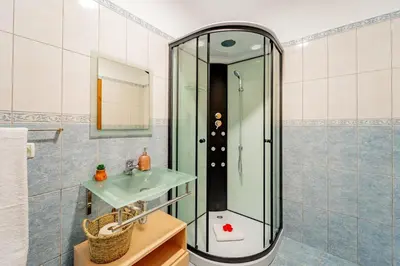 a bathroom with a shower and a sink at Refúgio das Fontes in Senhora do Rosário
