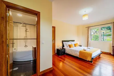 a bedroom with a bed and a bath tub at Refúgio das Fontes in Senhora do Rosário