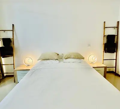 a large white bed with two night stands and two lamps at Carreira Solar by Olá Madeira in Funchal