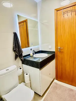 a bathroom with a white toilet and a sink at Carreira Solar by Olá Madeira in Funchal