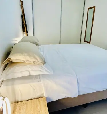 a bed with white sheets and pillows in a room at Carreira Solar by Olá Madeira in Funchal