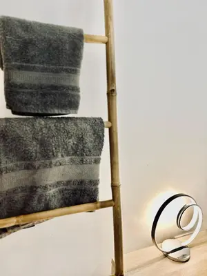 a wooden towel rack with a towel at Carreira Solar by Olá Madeira in Funchal
