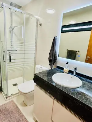 a bathroom with a sink and a shower and a toilet at Carreira Solar by Olá Madeira in Funchal