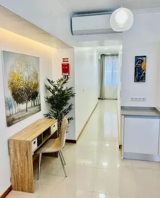 a living room with a table and a plant at Carreira Solar by Olá Madeira in Funchal