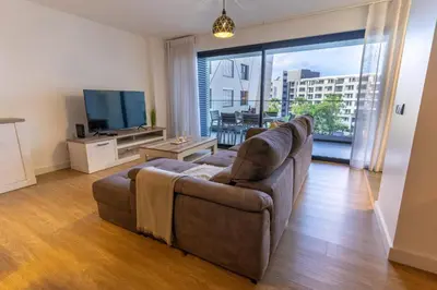 a living room with a couch and a flat screen tv at São Lucas apartamento com piscina e parking no Funchal in Funchal