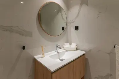 a bathroom with a sink and a mirror at São Lucas apartamento com piscina e parking no Funchal in Funchal