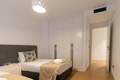 a bedroom with a bed and a large closet at São Lucas apartamento com piscina e parking no Funchal in Funchal