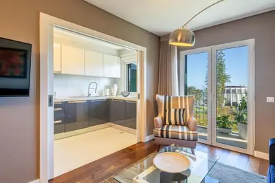a living room with a chair and a table at Manny Quinta Vitória, by Pausa Holiday Rentals in Funchal