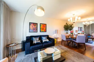 a living room with a couch and a dining room at Manny Quinta Vitória, by Pausa Holiday Rentals in Funchal