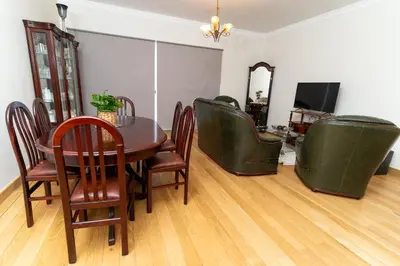 a dining room with a table and green chairs at Varandas da Caldeira by Madeira ReAL in Câmara de Lobos