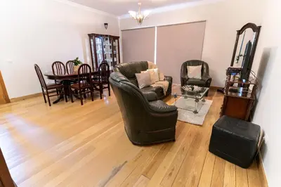 a living room with a leather chair and a table at Varandas da Caldeira by Madeira ReAL in Câmara de Lobos