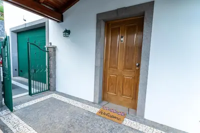 a door with a sign in front of a house at Varandas da Caldeira by Madeira ReAL in Câmara de Lobos