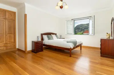 a bedroom with a bed and a window at Varandas da Caldeira by Madeira ReAL in Câmara de Lobos