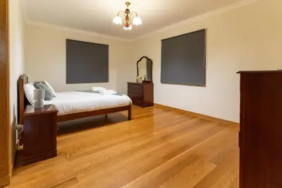 a bedroom with a bed and a dresser and a mirror at Varandas da Caldeira by Madeira ReAL in Câmara de Lobos