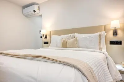 a large white bed with white sheets and pillows at BSE15 Apartments 1A, a Home in Madeira in Funchal
