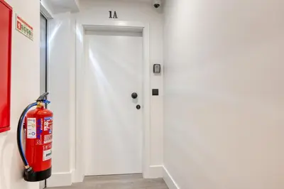 a fire extinguisher in front of a white door at BSE15 Apartments 1A, a Home in Madeira in Funchal