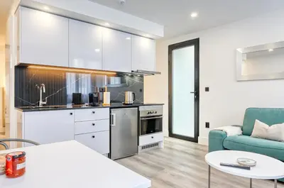 a kitchen and living room with a couch and a table at BSE15 Apartments 1A, a Home in Madeira in Funchal