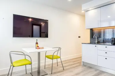 a kitchen with a white table and two chairs at BSE15 Apartments 1A, a Home in Madeira in Funchal