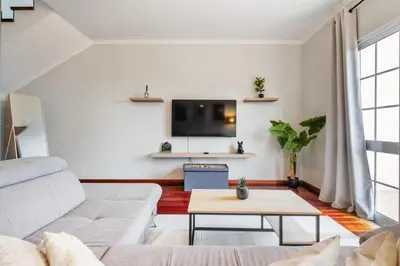 a living room with a couch and a tv at Ocean Flyby in Gaula