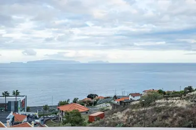 a view of the ocean from a city with houses at Ocean Flyby in Gaula