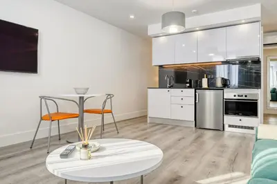 a kitchen and living room with a table and chairs at BSE15 Apartments 3I, a Home in Madeira in Funchal