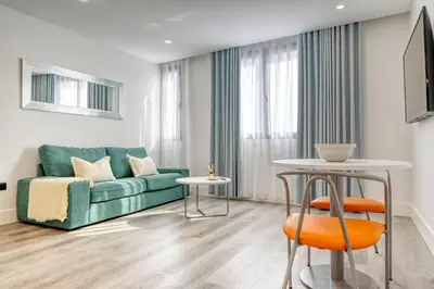 a living room with a green couch and a table at BSE15 Apartments 3I, a Home in Madeira in Funchal