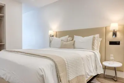 a bedroom with a large bed with white sheets and pillows at BSE15 Apartments 3I, a Home in Madeira in Funchal