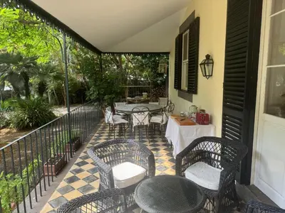 a patio with a table and chairs and a table at Quinta Dias in Funchal