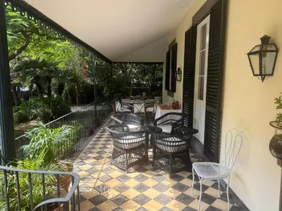 a patio with chairs and a table on a porch at Quinta Dias in Funchal