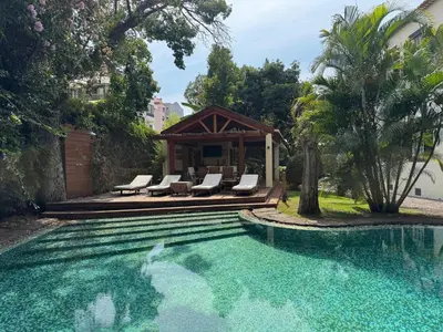 a swimming pool with lounge chairs and a house at Quinta Dias in Funchal