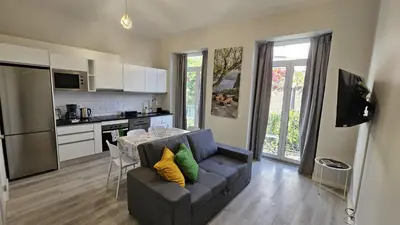 a living room with a couch and a kitchen at TIME OFF Madeira in Funchal