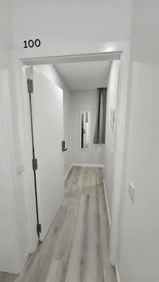 an empty hallway with white walls and wood floors at TIME OFF Madeira in Funchal