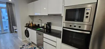 a kitchen with a stove and a microwave at TIME OFF Madeira in Funchal